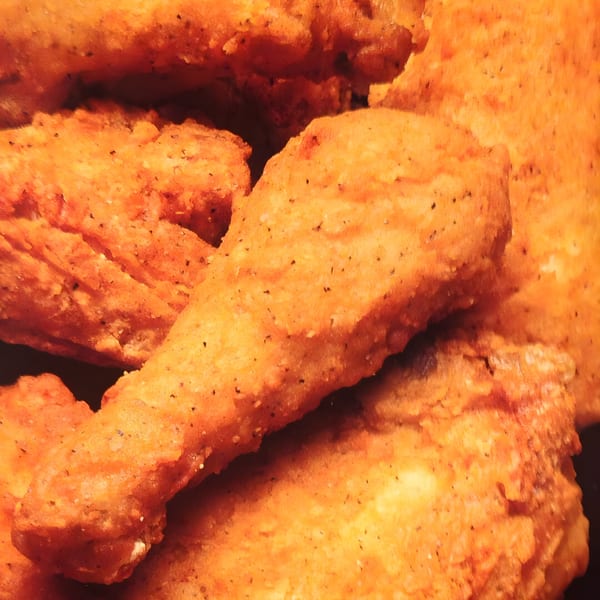 Close-up of crispy, golden-brown fried chicken pieces from Townies Feel Good Food.